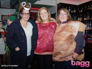 A woman wearing a poop emoji hat poses with women dressed in a peanut butter and jelly couples costume