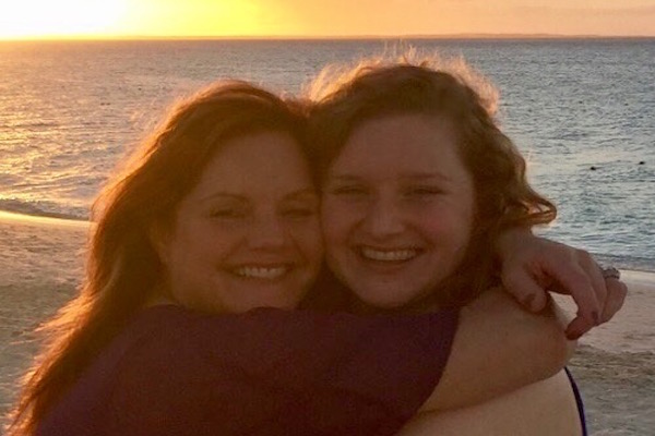 Sam and her mom hugging on the beach