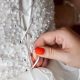 Hand tying a wedding dress