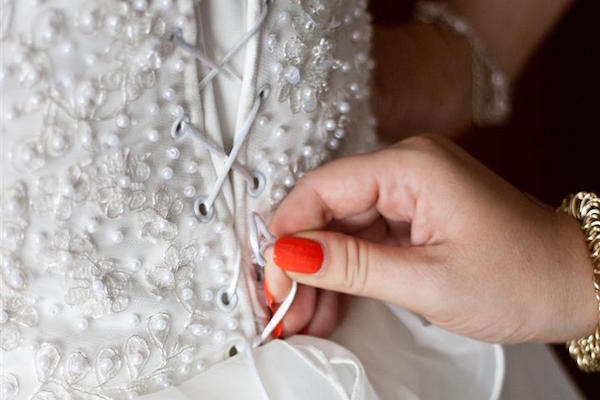 Hand tying a wedding dress