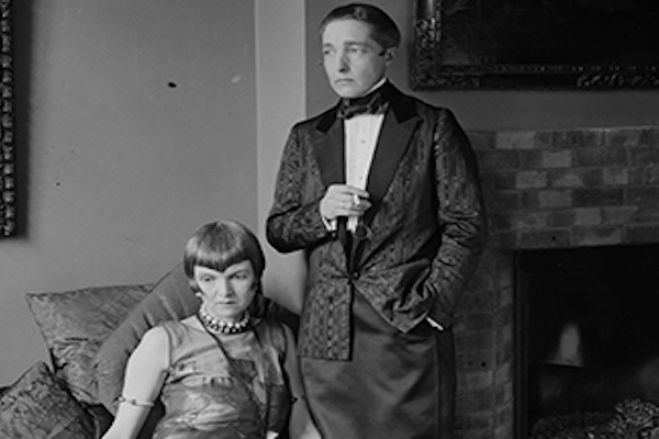 Radclyffe Hall standing with drink in hand (right)