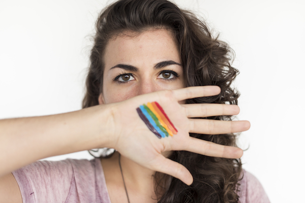Woman with rainbow flag hands
