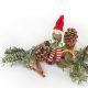 Little elf sitting on tinsel/christmas tree