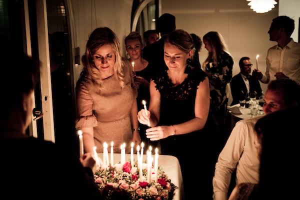 Women with holiday candles at family function