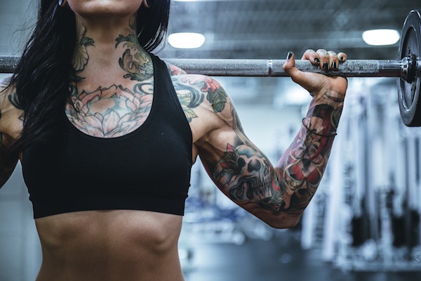 Tattooed woman working out
