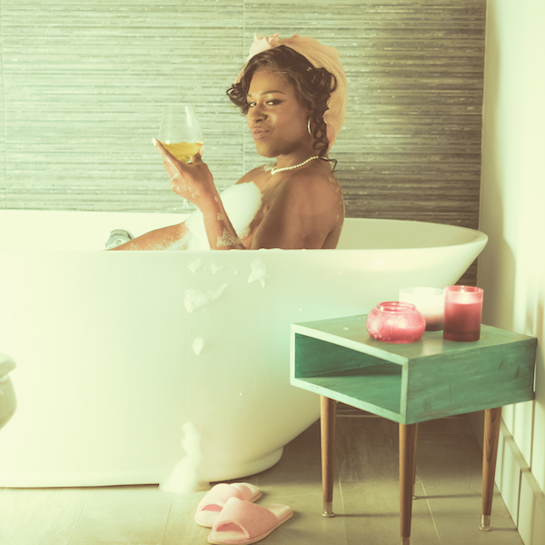 Shea Diamond in bathtub drinking wine