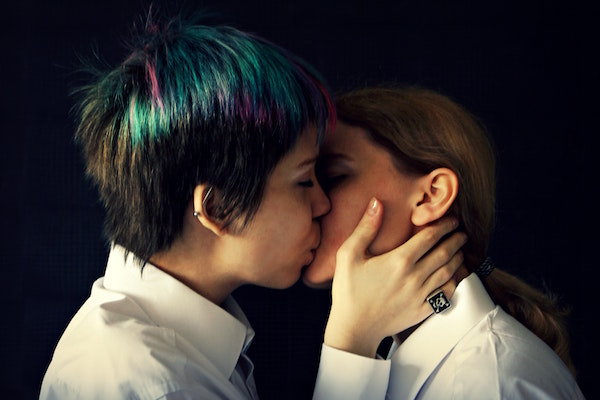 Two young women kissing