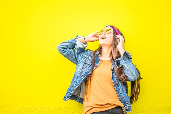 Cheerful bold woman with yellow background