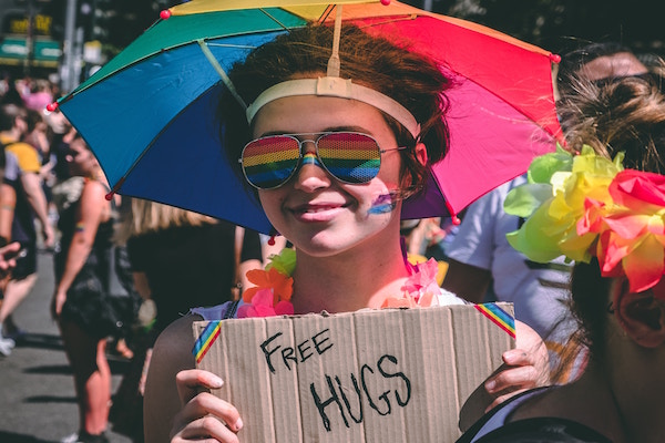 Young woman with free hugs sign