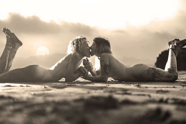 Women kissing on beach