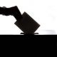 Person dropping paper in ballot box