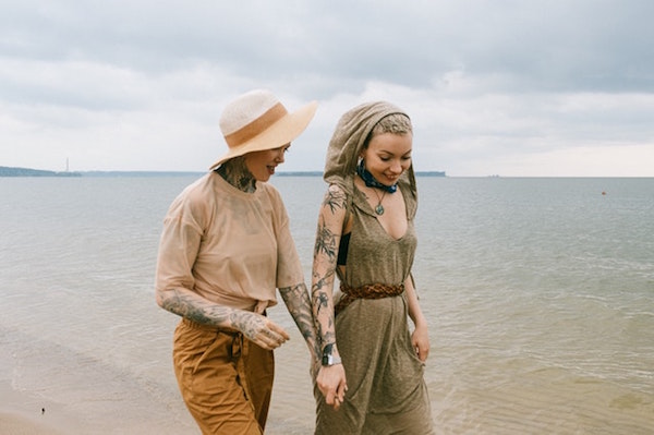 Lesbian couple walking on beach