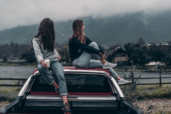 Women outdoors on car