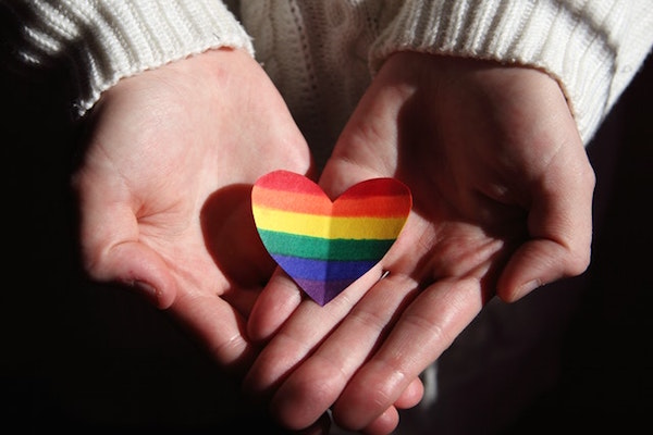 Holding rainbow heart