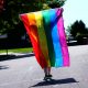 Holding up rainbow flag