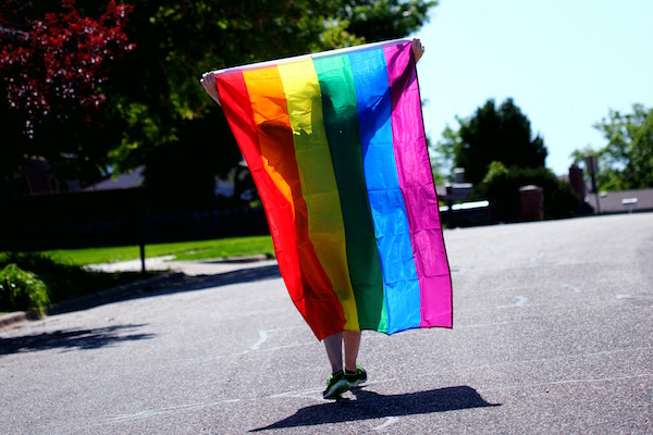 Holding up rainbow flag
