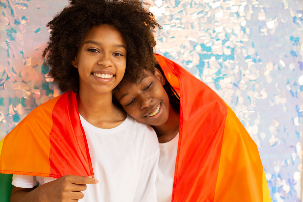 two black people with rainbow flag