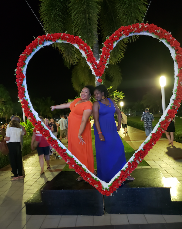 Courtney Ramsey and Robin Flemming pose under heart
