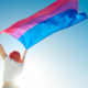 woman with red hair with bi pride flag
