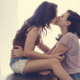 Queer women kiss passionately