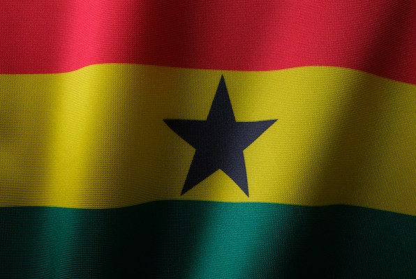 The national flag of Ghana. It is a horizontal triband of red, yellow, and green. In the middle there is a solid black star.