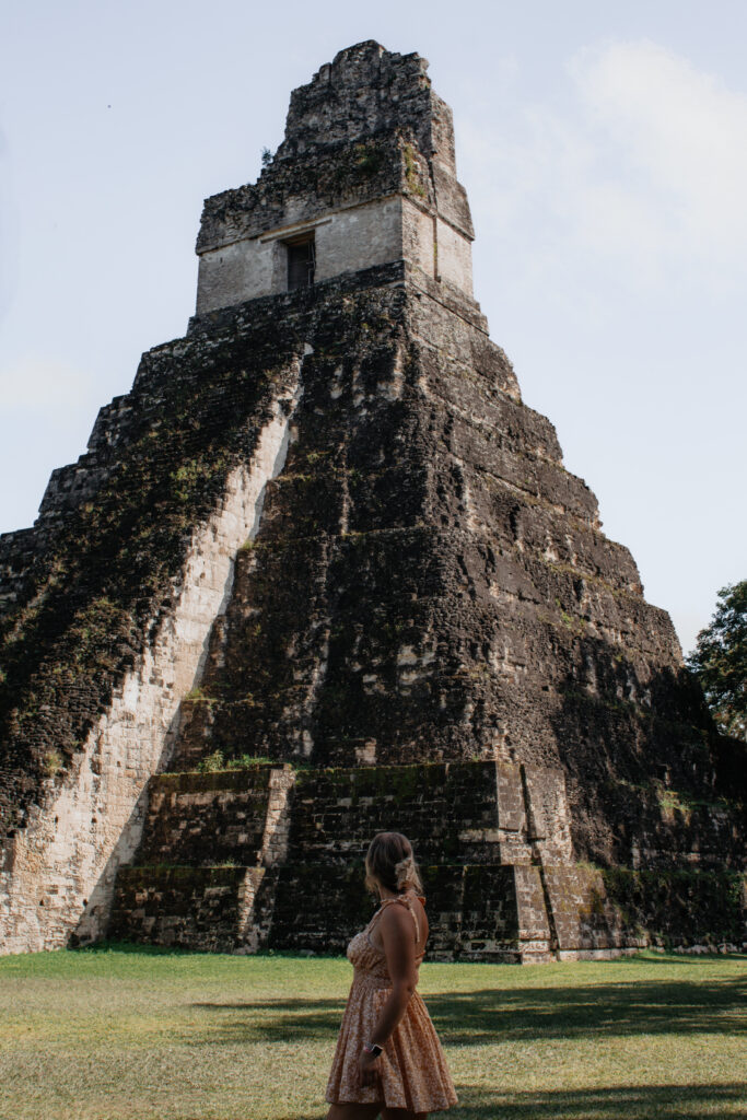 Allyssa Leaton of @thelesbian passport stands at the bottom of a Mayan pyramid in Tikal, Guatemala.