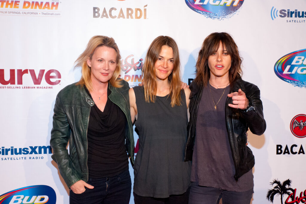 L Word co-stars Laurel Holloman, Leisha Hailey, Kate Moennig stand against a step and repeat at The Dinah in 2014. 