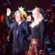 The Dinah founder Mariah Hanson, wears a crown as she stands on stage with Megan Trainor.