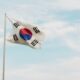 South Korea's flag flies high in a blue sky.