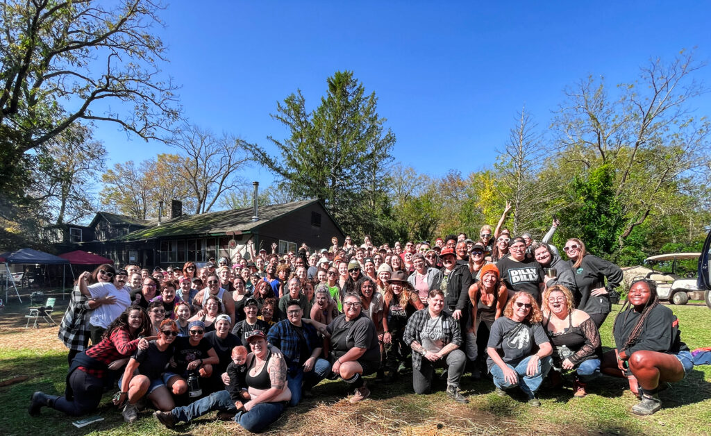 Dozens of campers pose together for a group photo.