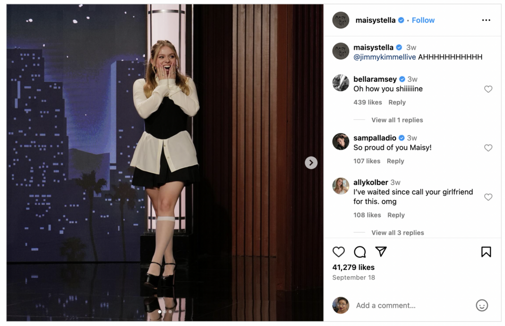 A screenshot of Maisy Stella's Instagram, showing her on the Jimmy Kimmel Show. On the right, the comment sections shows a comment from Bella Ramsey reading, "Oh how you shiiiiiiiiine."