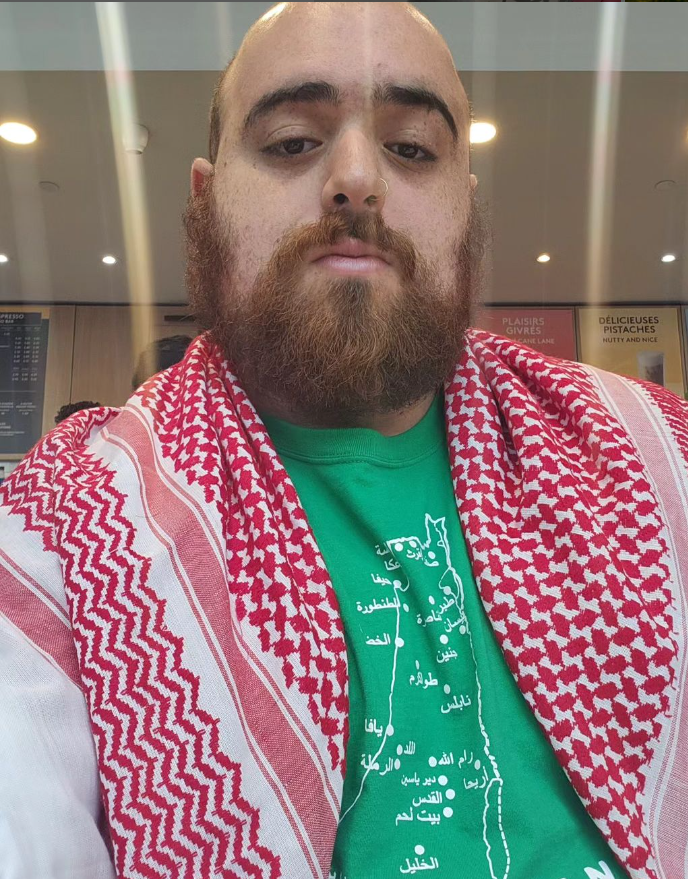 Poet George Abraham poses in ared Keffiyeh.