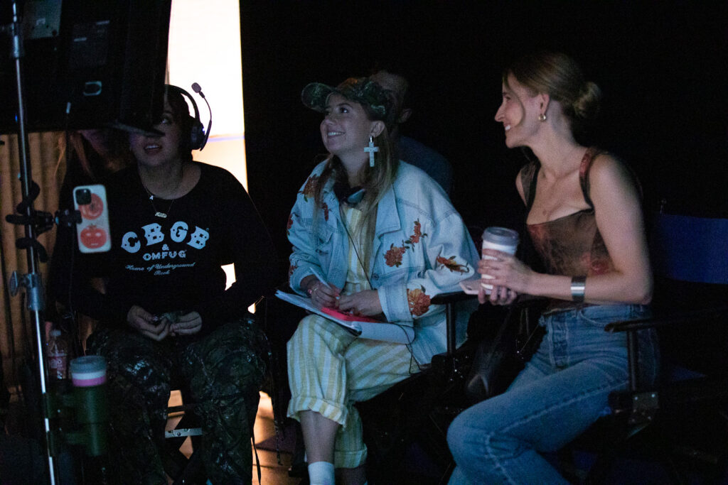 From left, Director Jasia Ka and Actor/Writer Ann Marie Wilding sit on set watching back scenes.