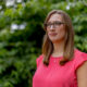 Sarah McBride sands outside with a confident look on her face.