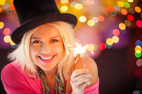 Woman smiling in sparkling NYE gear