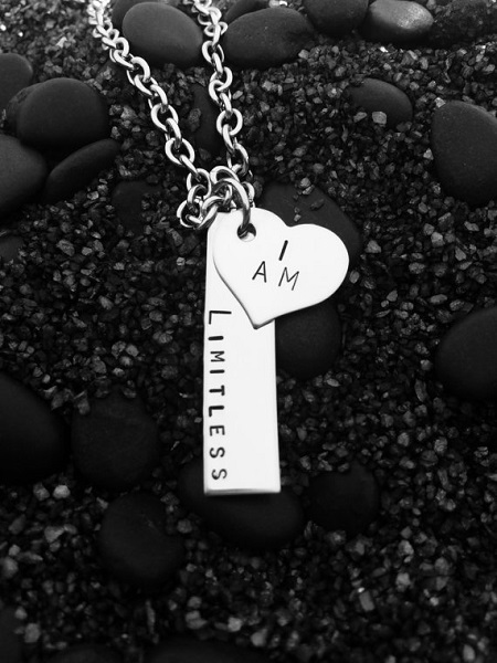 I am limitless necklace. A stainless steel necklace with two pendants: a heart that says "I am" and a rectangle that says "limitless
