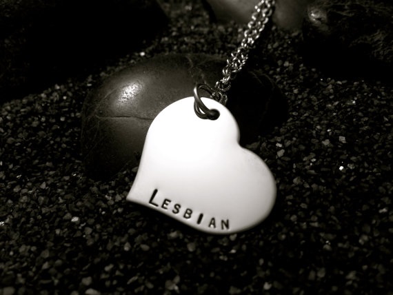 Heart-shaped stainless steel necklace that says "lesbian"