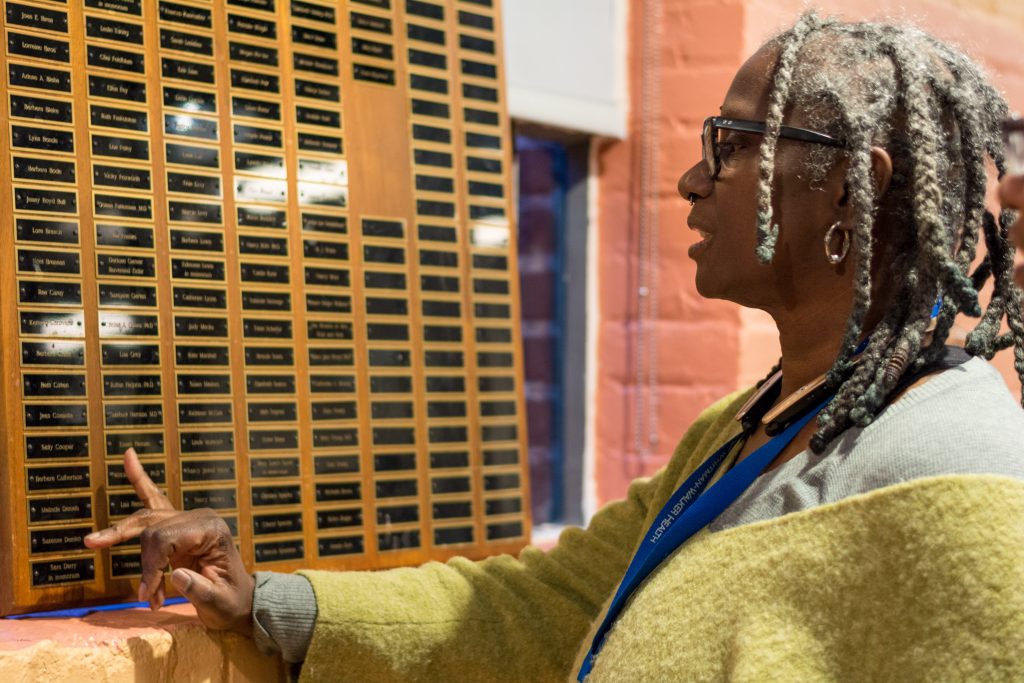 Community Commitment & Training Coordinator D. Magrini looks at the Lesbian Honor Roll plaque