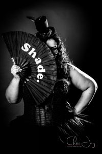 Burlesque performer Ginger Snapz with shade fan